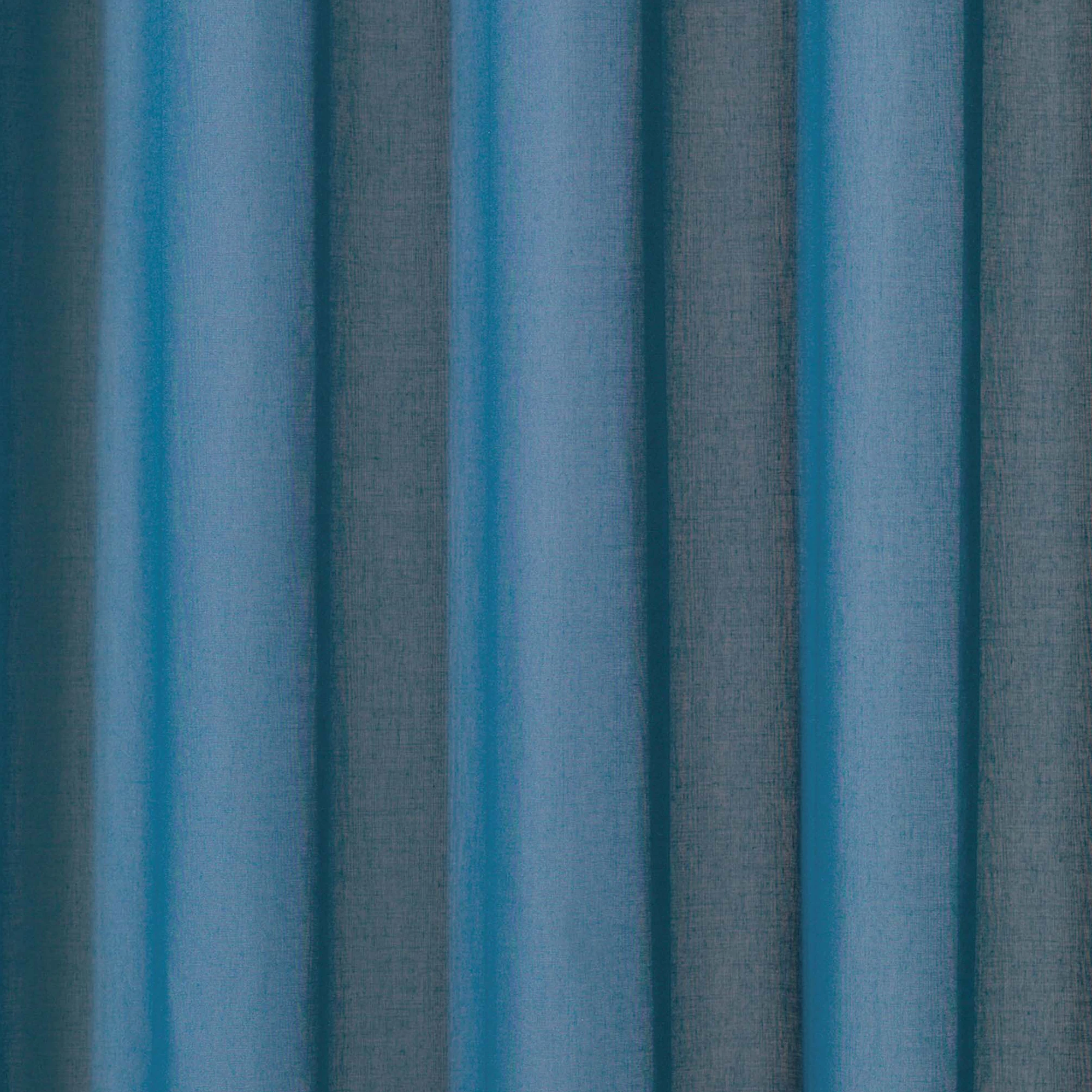 Juno inbetween transparent curtain fabric with a super soft texture, made from 100% flame-retardant polyester, shown as flowing blue-toned drapery that falls gracefully, suitable for project use and Roman blinds, OEKO-TEX certified.