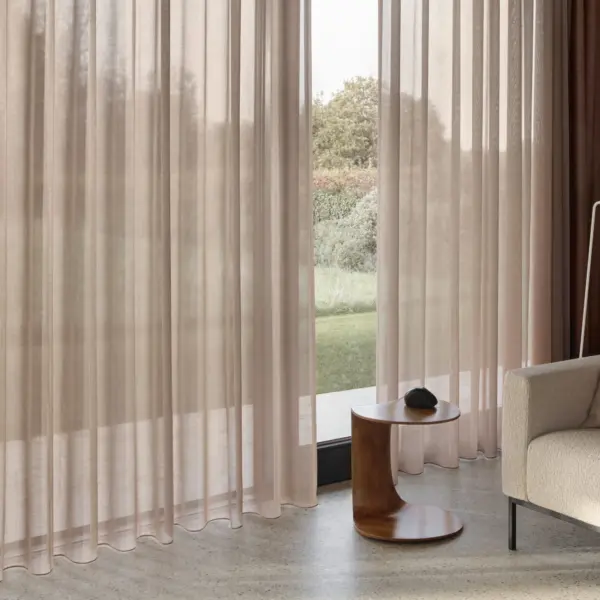 Ebben room-high sheer curtain fabric with subtle two-tone effect, made from 100% polyester, shown as inbetween transparent drapery in a calm modern living room with floor-to-ceiling windows, soft neutral interiors, and natural daylight filtering through the fabric, OEKOTEX certified.