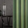 Mizu sheer curtain fabric close-up with a colorfully woven inbetween transparent texture, made from 100% Trevira CS polyester, featuring a soft natural feel with subtle shimmer and shifting yarn colors inspired by water, OEKOTEX certified.