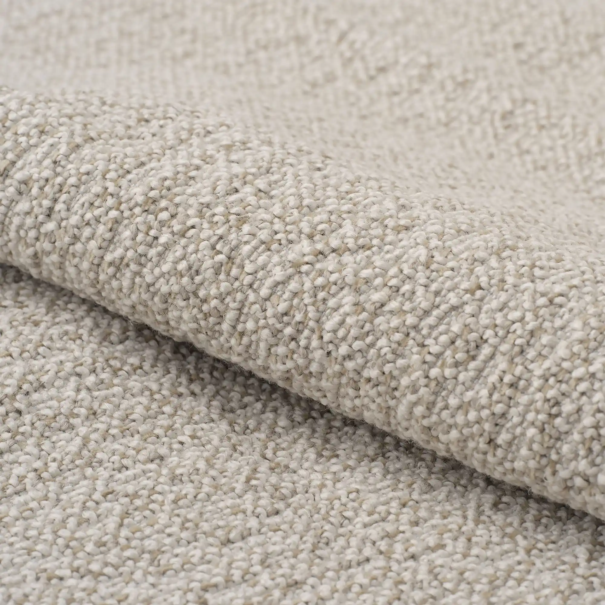 Serra upholstery fabric close-up showing a luxurious dense woven texture, made from a refined blend of acrylic, polyester, cotton, linen, viscose, and polyamide, featuring soft earthy tones and a natural yet premium look, designed for heavy-duty upholstery use, OEKOTEX certified.