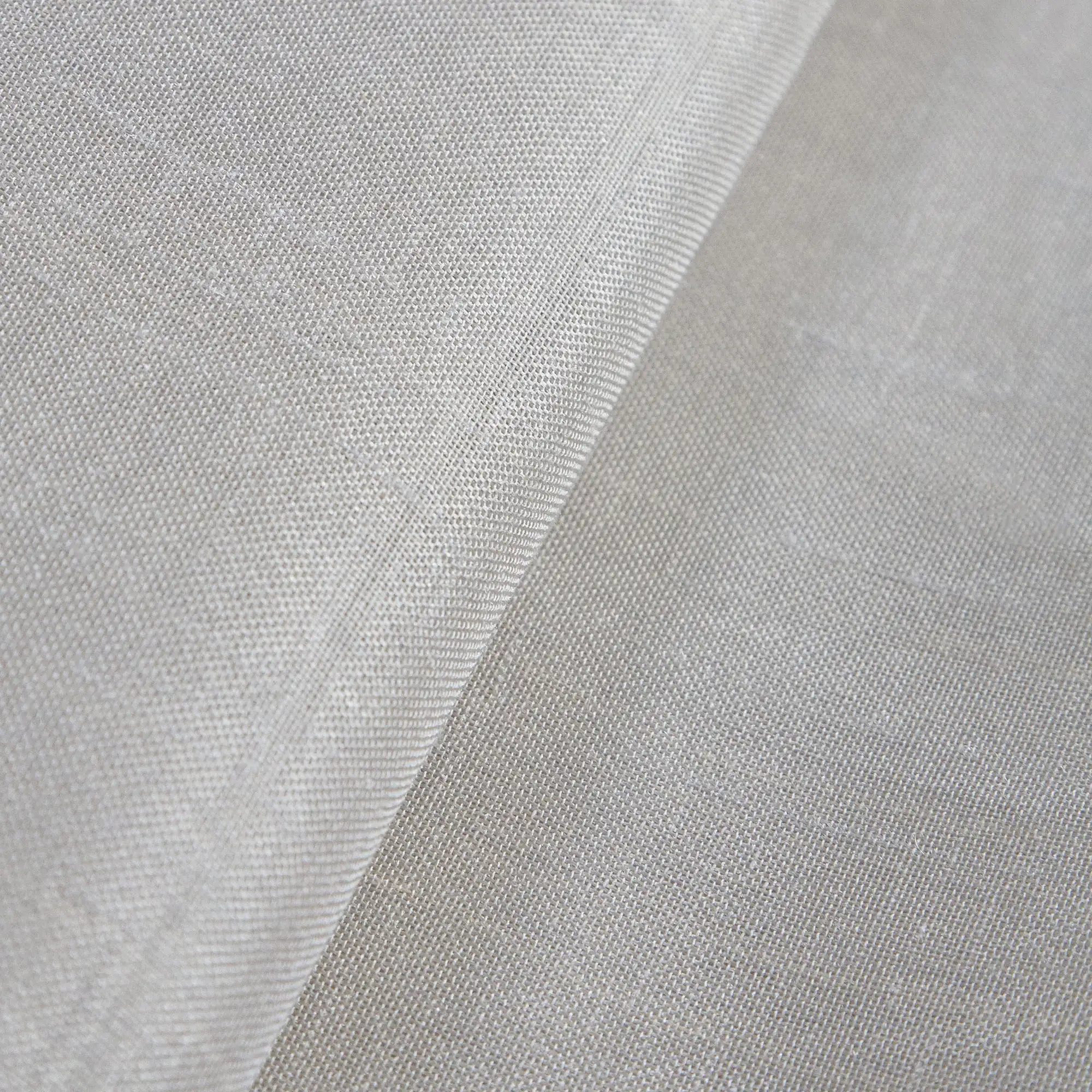 Solar sheer curtain fabric close-up with an inbetween transparent weave and subtle reflective sheen, made from 100% polyester, featuring soft natural stone tones and smooth light-filtering texture, suitable for Roman blinds.