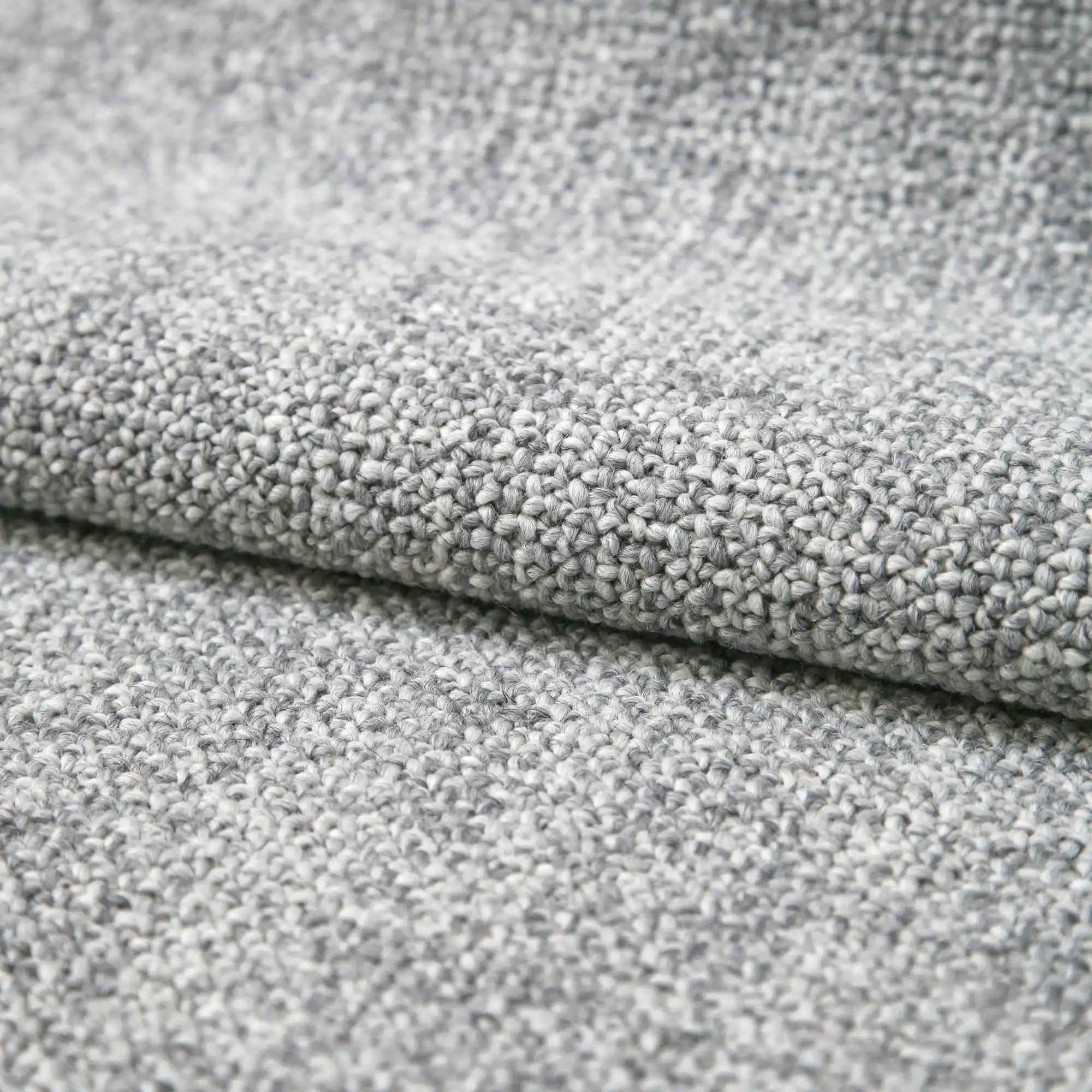 Taro upholstery fabric close-up with a dense woven texture, made from a blend of new wool, polyester, and cotton, featuring a soft tactile feel and timeless earthy tones, designed for elegant and durable interior upholstery, OEKOTEX certified.