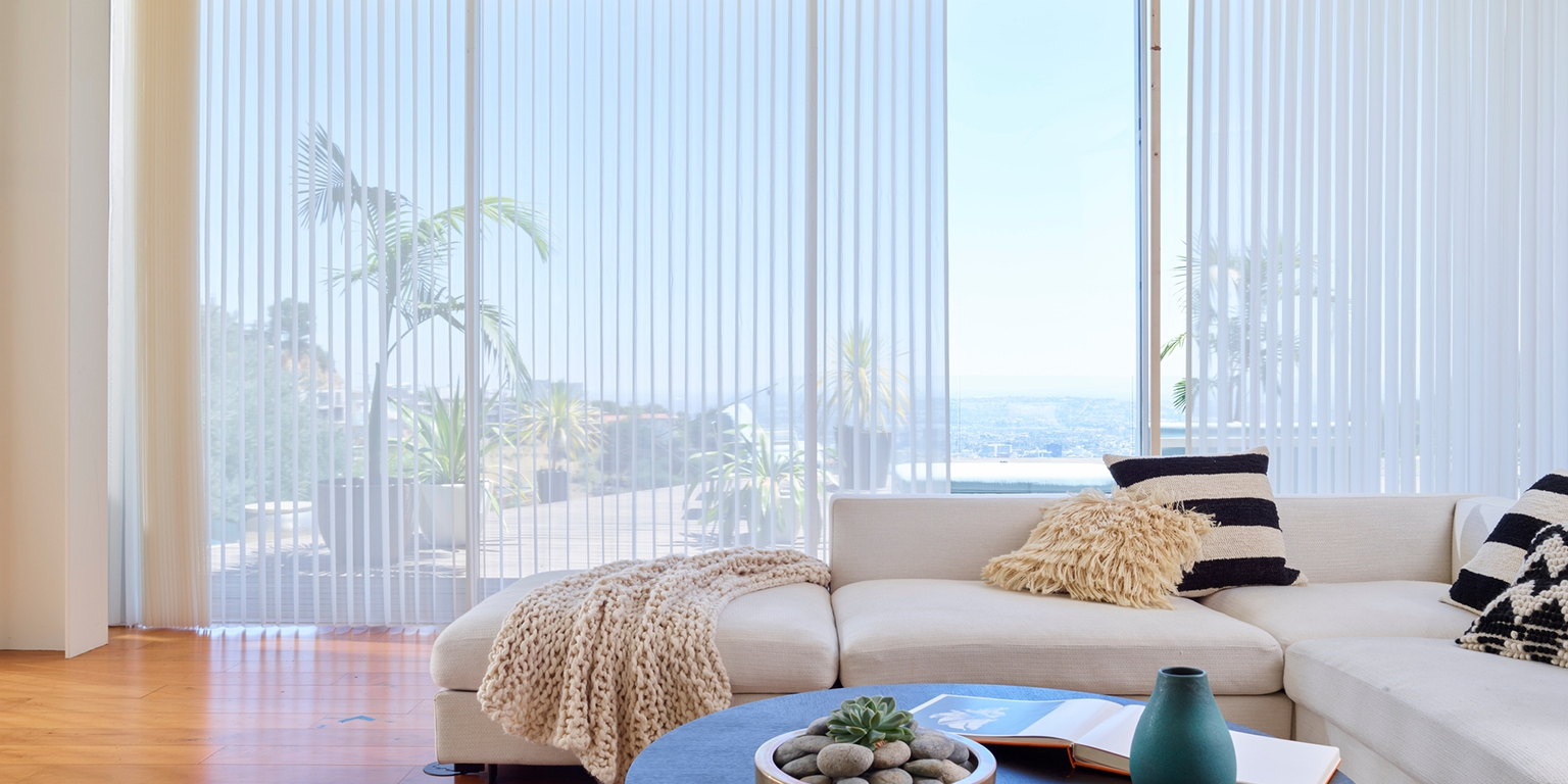 Modern sliding glass doors fitted with motorised Luminette® Privacy Sheers, featuring elegant sheer fabric and 180-degree rotating vertical vanes that allow homeowners to adjust natural light, maintain daytime privacy, and enjoy unobstructed outdoor views.